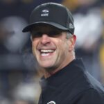 Baltimore Ravens head coach John Harbaugh reacts on the field before the game against the Pittsburgh Steelers at Acrisure Stadium.
