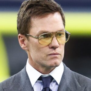 Former NFL quarterback Tom Brady looks on from the sideline before the game between the Philadelphia Eagles and Dallas Cowboys at AT&T Stadium.