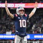 New England Patriots quarterback Drake Maye (10) reacts to a Patriots touchdown scored against the Miami Dolphins during the first quarter at Gillette Stadium.