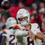 Denver Broncos quarterback Jarrett Stidham (8) warms up before the game at GEHA Field at Arrowhead Stadium.