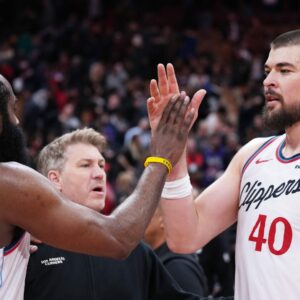 Jan 16, 2026; Toronto, Ontario, CAN; LA Clippers guard James Harden (1) celebrates the win with center Ivica Zubac (40) against the Toronto Raptor at the end of the overtime period at Scotiabank Arena