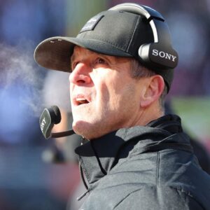 Baltimore Ravens head coach John Harbaugh checks a replay during the second quarter against the Cincinnati Bengals at Paycor Stadium.