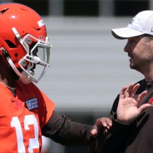 Browns quarterback Shedeur Sanders works with offensive coordinator Tommy Rees during rookie minicamp May 9, 2025, in Berea.