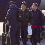 Patriots players board the team jet for Denver on Saturday, Jan. 24, at Rhode Island T.F. Green International Airport in Warwick.