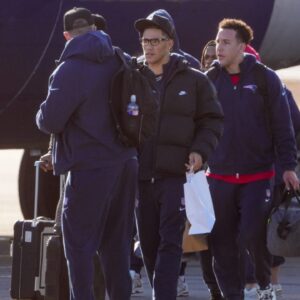 Patriots players board the team jet for Denver on Saturday, Jan. 24, at Rhode Island T.F. Green International Airport in Warwick.