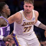 Dec 28, 2025; Los Angeles, California, USA; Sacramento Kings guard Dennis Schroder (17) defemds Los Angeles Lakers guard Luka Doncic (77) in the second half at Crypto.com Arena.