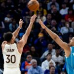 Golden State Warriors guard Stephen Curry (30) takes a three-point shot as Charlotte Hornets forward Grant Williams (2) defends during the third quarter at Chase Center