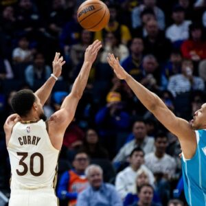 Golden State Warriors guard Stephen Curry (30) takes a three-point shot as Charlotte Hornets forward Grant Williams (2) defends during the third quarter at Chase Center