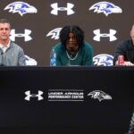 Baltimore Ravens head coach John Harbaugh, quarterback Lamar Jackson, and general manager Eric DeCosta listen to a question asked at a press conference at Under Armour Performance Center.