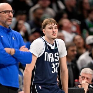 Dallas Mavericks head coach Jason Kidd and forward Cooper Flagg (32) look on during the game between the Mavericks and the 76ers at American Airlines Center.