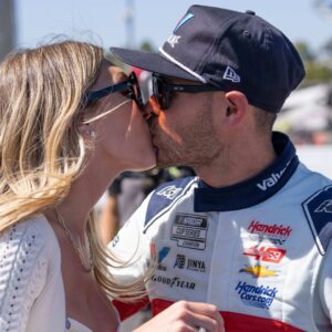 Jun 9, 2024; Sonoma, California, USA; Katelyn Sweet, wife of NASCAR Cup Series driver Kyle Larson, gives him a kiss after he won the Toyota / Save Mart 350 at Sonoma Raceway