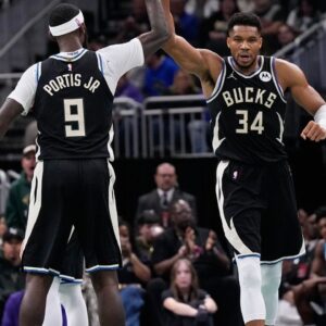 Milwaukee Bucks forward Giannis Antetokounmpo high fives forward Bobby Portis (9) during the second quarter at Fiserv Forum.