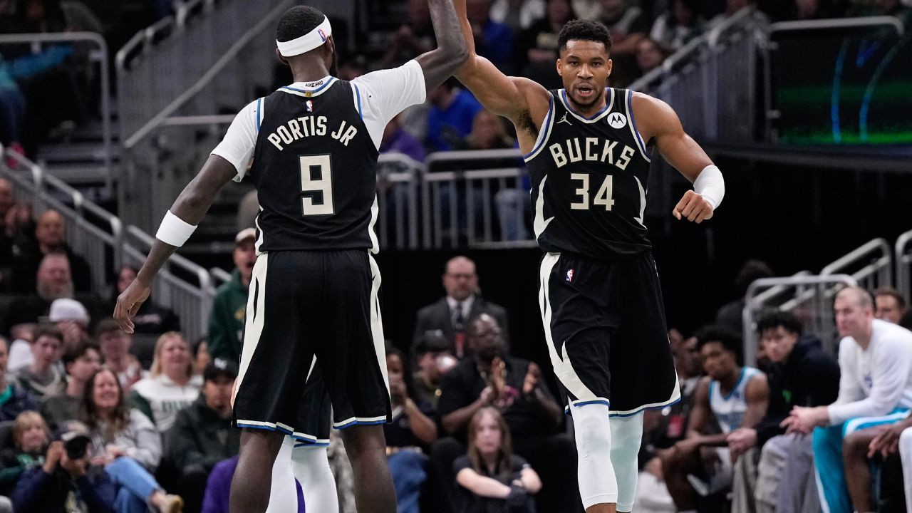 Milwaukee Bucks forward Giannis Antetokounmpo high fives forward Bobby Portis (9) during the second quarter at Fiserv Forum.