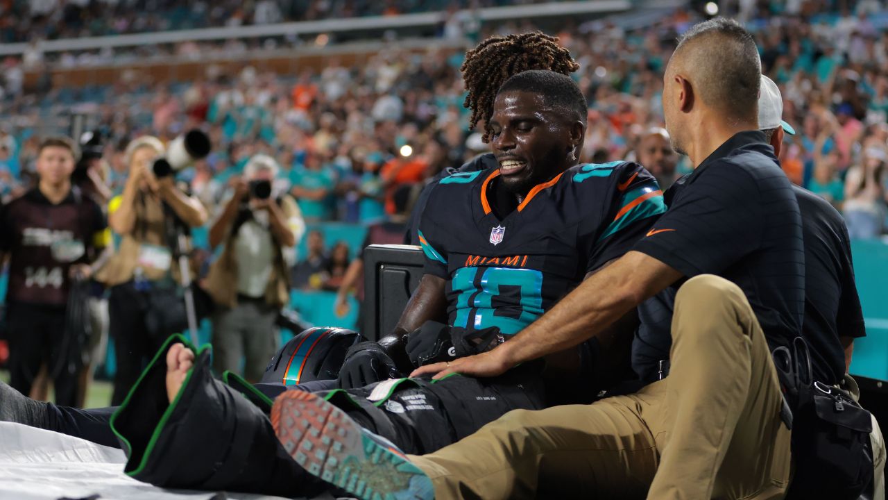 Miami Dolphins wide receiver Tyreek Hill (10) reacts after being placed on a medical cart against the New York Jets during the second half at Hard Rock Stadium.