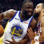 Dec 18, 2025; Phoenix, Arizona, USA; Golden State Warriors forward Draymond Green (23) against Phoenix Suns forward Dillon Brooks in the first half at Mortgage Matchup Center.