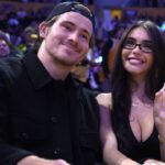 Los Angeles Chargers quarterback Justin Herbert (left) and girlfriend Madison Beer attend the game between the Minnesota Timberwolves and the Los Angeles Lakers at Crypto.com Arena.