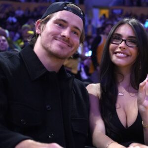 Los Angeles Chargers quarterback Justin Herbert (left) and girlfriend Madison Beer attend the game between the Minnesota Timberwolves and the Los Angeles Lakers at Crypto.com Arena.