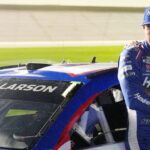 Kyle Larson waits by his car before the NASCAR Cup Series Duel during Speedweek, Thursday, Feb. 12, 2026.