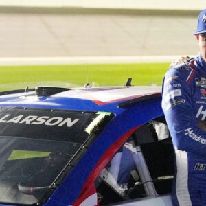 Kyle Larson waits by his car before the NASCAR Cup Series Duel during Speedweek, Thursday, Feb. 12, 2026.