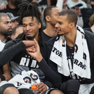 Feb 7, 2026; San Antonio, Texas, USA; San Antonio Spurs forward Victor Wembanyama (1) shakes the hand of guard Stephon Castle (5) during the second half against Dallas Mavericks at Frost Bank Center.