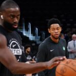 Boston Celtics guard Anfernee Simons (4) and guard/forward Jaylen Brown (7) warm up before the start of the game against the Washington Wizards at TD Garden.