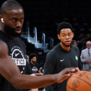 Boston Celtics guard Anfernee Simons (4) and guard/forward Jaylen Brown (7) warm up before the start of the game against the Washington Wizards at TD Garden.