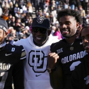 Colorado Buffaloes safety Shilo Sanders (21) and head coach Deion Sanders and quarterback Shedeur Sanders (2) and social media producer Deion Sanders Jr. following the win against the Oklahoma State Cowboys at Folsom Field.