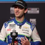 Feb 11, 2026; Daytona Beach, Florida, USA; NASCAR Cup Series driver Daniel Suarez (7) speaks to the media during the Daytona 500 Media Day at Daytona International Speedway.