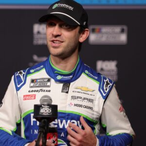 Feb 11, 2026; Daytona Beach, Florida, USA; NASCAR Cup Series driver Daniel Suarez (7) speaks to the media during the Daytona 500 Media Day at Daytona International Speedway.