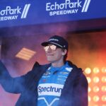Feb 22, 2026; Hampton, Georgia, USA; NASCAR Cup Series driver Carson Hocevar waves during introductions at EchoPark Speedway.