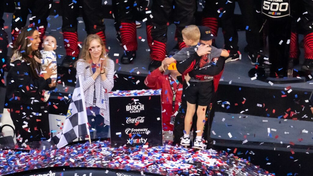 Feb 15, 2026; Daytona Beach, Florida, USA; NASCAR Cup Series driver Tyler Reddick (45) celebrates with son Beau Reddick as wife Alexa DeLeon holds son Rookie Reddick in victory lane after winning the 68th running of the Daytona 500 at Daytona International Speedway.