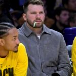 Feb 12, 2026; Los Angeles, California, USA; Los Angeles Lakers guard Luka Doncic (77) looks on from the bench as he chews on a dental flosser in the second half against the Dallas Mavericks at Crypto.com Arena.