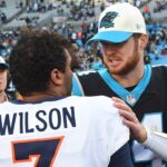 Carolina Panthers quarterback Sam Darnold (14) with Denver Broncos quarterback Russell Wilson (3) after the game at Bank of America Stadium.