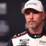 DAYTONA BEACH, FL - FEBRUARY 11: Denny Hamlin ( 11 Joe Gibbs Racing National Debt Relief Toyota) is being interviewed during Media Day for the NASCAR, Motorsport, USA Cup Series Daytona 500 on February 11, 2026 at Daytona International Speedway in Daytona Beach, FL