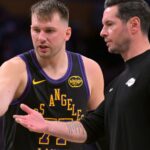 Jan 2, 2026; Los Angeles, California, USA; Los Angeles Lakers guard Luka Doncic (77) talks with head coach JJ Redick during a time out in the second half against the Memphis Grizzlies at Crypto.com Arena
