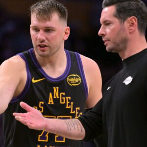 Jan 2, 2026; Los Angeles, California, USA; Los Angeles Lakers guard Luka Doncic (77) talks with head coach JJ Redick during a time out in the second half against the Memphis Grizzlies at Crypto.com Arena