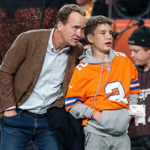 Former Denver Broncos player Peyton Manning with his son Marshall before the game against the Cleveland Browns at Empower Field at Mile High.
