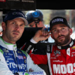 Aug 19, 2023; Watkins Glen, New York, USA; NASCAR Cup Series driver Daniel Suarez (left) and driver Ross Chastain (right) look on during practice and qualifying for the Go Bowling at The Glen at Watkins Glen International. Mandatory Credit: Matthew O'Haren-Imagn Images