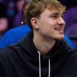 Feb 20, 2026; Minneapolis, Minnesota, USA; Dallas Mavericks forward Cooper Flagg (32) watches the second quarter against the Minnesota Timberwolves at Target Center