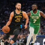 Golden State Warriors guard Stephen Curry (30) dribbles past Boston Celtics forward Jaylen Brown (7) in the third quarter at the Chase Center.