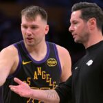 Los Angeles Lakers guard Luka Doncic (77) talks with head coach JJ Redick during a time out in the second half against the Memphis Grizzlies at Crypto.com Arena