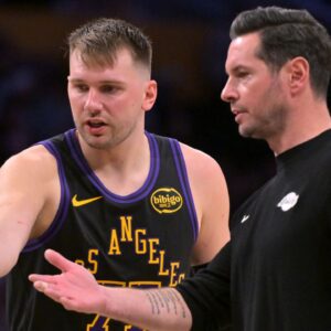 Los Angeles Lakers guard Luka Doncic (77) talks with head coach JJ Redick during a time out in the second half against the Memphis Grizzlies at Crypto.com Arena