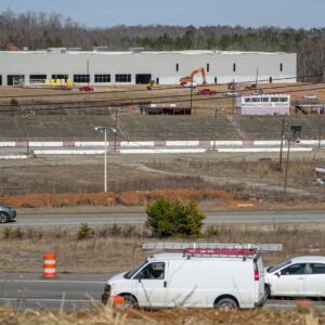 Cars drive along State Highway 123 by the former Greenville-Pickens Speedway and the construction of the Speedway Industrial Park in the city of Easley in Pickens County, SC in February 2026.