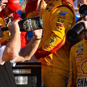 Feb 22, 2015; Daytona Beach, FL, USA; NASCAR Sprint Cup Series driver Joey Logano (22) celebrates with team owner Roger Penske in victory lane after winning the Daytona 500 at Daytona International Speedway