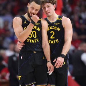 May 4, 2025; Houston, Texas, USA; Golden State Warriors guard Stephen Curry (30) and guard Brandin Podziemski (2) talk during a timeout during game seven of first round for the 2025 NBA Playoffs against the Houston Rockets at Toyota Center