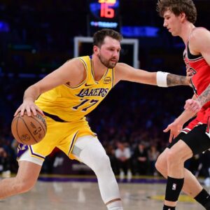 Los Angeles Lakers guard Luka Doncic (77) moves the ball against Chicago Bulls forward Matas Buzelis (14) during the first half at Crypto.com Arena.