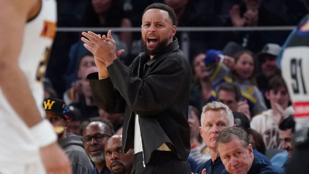 Golden State Warriors guard Stephen Curry (30) cheers from the bench during a game against the Denver Nuggets in the third quarter at Chase Center.