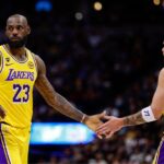 Los Angeles Lakers forward LeBron James (23) and guard Luka Doncic (77) in the first quarter against the Denver Nuggets at Ball Arena