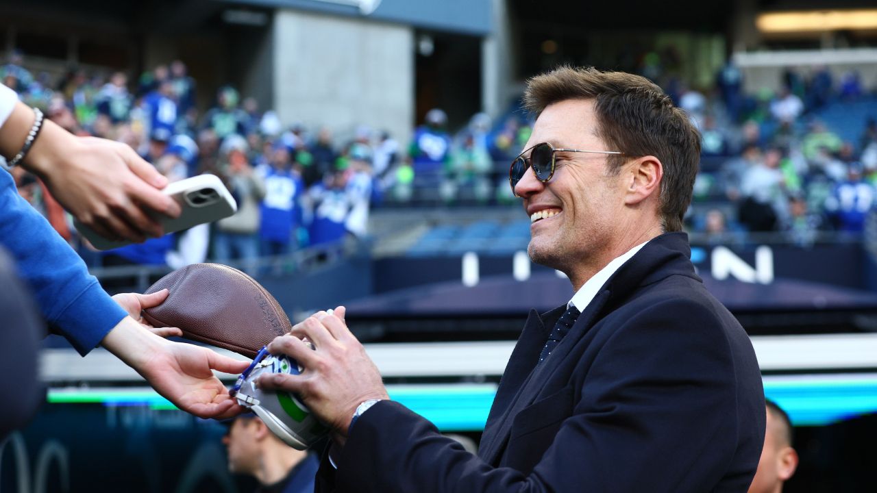 Tom Brady signs autographs before the 2026 NFC Championship Game between the Seattle Seahawks and the Los Angeles Rams at Lumen Field.