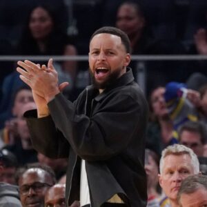 Feb 22, 2026; San Francisco, California, USA; Golden State Warriors guard Stephen Curry (30) cheers from the bench during a game against the Denver Nuggets in the third quarter at Chase Center. Mandatory Credit: David Gonzales-Imagn Images